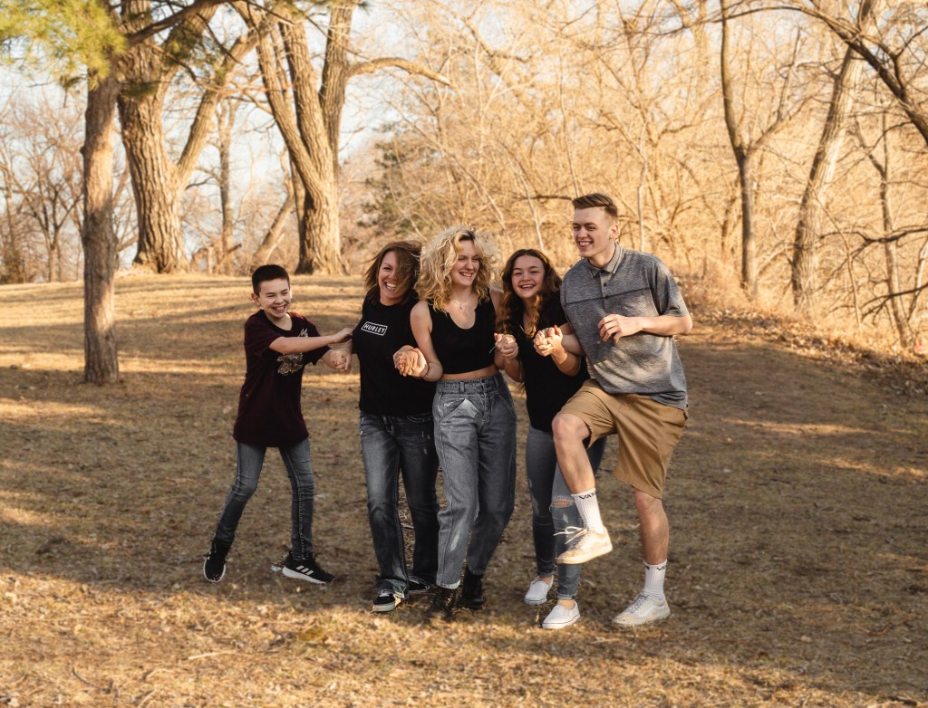 Mom and kids laughing during first photography session photographed by Sam Highsmith
