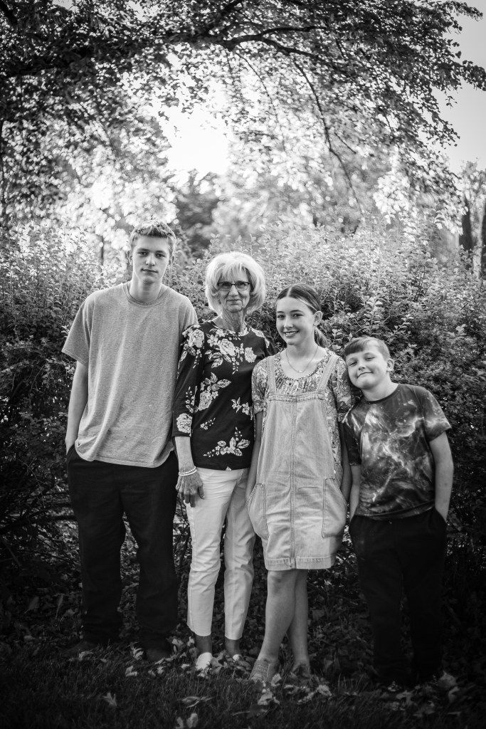 Black and white photo of grandma and grandkids 